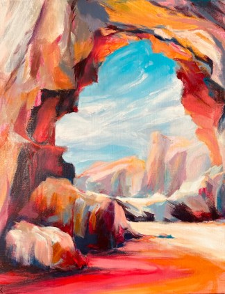 A rock formation painted in oranges and red curvers over to form an arch, looking through to the background are soft pinks showing the coastal cliffs in the distance. Above these the turquoise sky and soft full bodied clouds skim across.